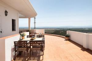 a patio with a table and chairs on a balcony at Cobijadas75 Janda in Vejer de la Frontera +14 photos