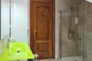 a bathroom with a green sink and a wooden door at Oiaraberri in Errazu +13 photos