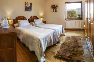 a bedroom with two beds and a window at Oiaraberri in Errazu