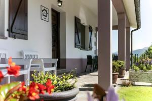 a balcony of a house with flowers and chairs at Oiaraberri in Errazu