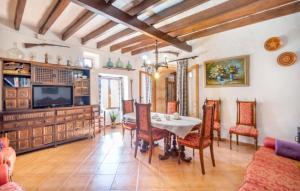 a dining room with a table and a tv at Son Gabriela in Llucmajor