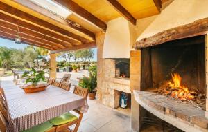 an outdoor patio with a fireplace and a table at Son Gabriela in Llucmajor