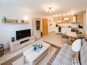 a living room with a couch and a tv at Ferienwohnung Storchenaue in Wächtersbach