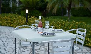 a white table with chairs and wine glasses on it at Masseria La Porticella in Avetrana +20 photos