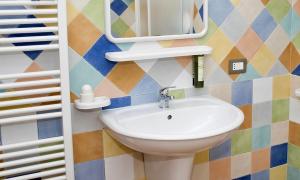 a bathroom with a sink and a mirror at Masseria La Porticella in Avetrana