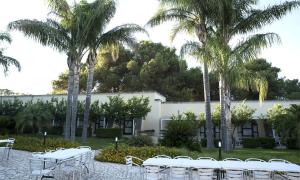 a group of tables and chairs in front of a building at Masseria La Porticella in Avetrana