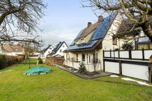 a house with a blue tarp in the yard at Ferienwohnung Sonnenring in Rüthen