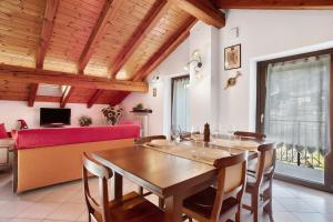 a dining room with a wooden table and chairs at Verger Plein Soleil in Saint-Pierre
