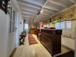 a living room with a wooden dresser in a room at Kavcıoğlu Rooms in Urla