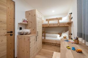 a childs room with a bunk bed and a play area at Apartment Mittermanting Villnöss in Villnoss