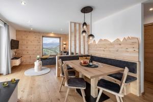a dining room and living room with a table and chairs at Apartment Mittermanting Villnöss in Villnoss