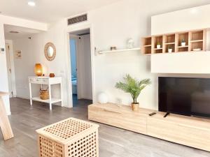 a living room with a large flat screen tv at Atico Solarium La Cala in Miami Platja
