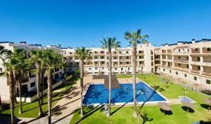 an aerial view of a resort with palm trees and a pool at Atico Solarium La Cala in Miami Platja