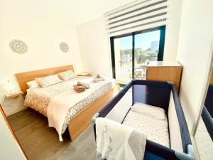 a bedroom with a bed and a large window at Atico Solarium La Cala in Miami Platja +37 photos