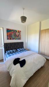 a bedroom with a large bed with a painting on the wall at Joude in Fez