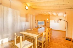 a dining room with a wooden table and chairs at Rectoria de Claverol in Claverol