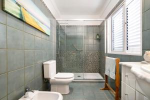a bathroom with a toilet and a shower and a sink at Casa Paca in Maspalomas +16 photos