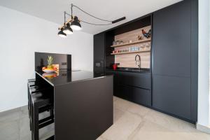 a kitchen with a black counter and a sink at Mar in Playa Honda