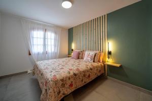 a bedroom with a bed and a green wall at Mar in Playa Honda