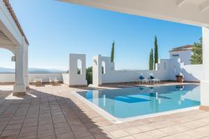 a villa with a swimming pool and a patio at Villa Muscari in Benalup Casas Viejas