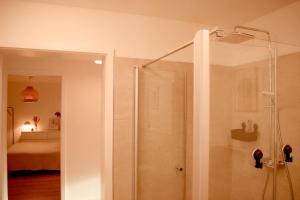 a shower with a glass door in a bathroom at Fewo Tenne in Menslage +19 photos