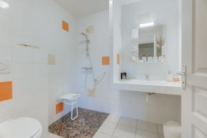 a white bathroom with a shower and a sink at Grain de vanille in Saint-Benoît-des-Ondes +19 photos