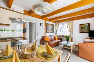 a kitchen and living room with a table and a couch at Atlanta Pur in Pellworm
