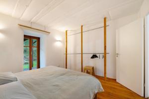 a bedroom with a white bed and a window at Alte Mühle in Dernbach in Dernbach