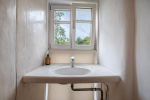 a sink in a bathroom with a window at Alte Mühle in Dernbach in Dernbach +15 photos
