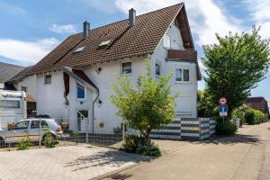 a white house with a brown roof at Ferienwohnung Leon in Kappel-Grafenhausen