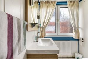 a bathroom with a sink and a window at Atlanta Pur in Pellworm +150 photos