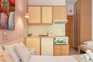 a small kitchen with a white refrigerator and a counter at Nontas Home 27 in Kalamitsi