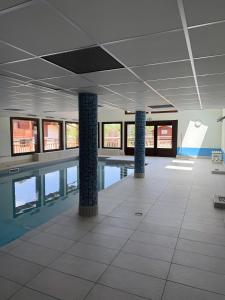 an empty building with a pool in the middle at Studio Edelweiss proche Megeve in Flumet