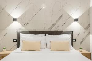 a bedroom with a white bed with two pillows at Piccolo Incanto Spa Palermo in Palermo