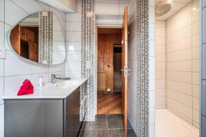 a bathroom with a sink and a mirror at Appartement chalet - Le Vnipi in Abondance +35 photos