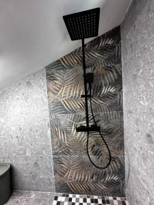 a shower in a bathroom with a wall at Nice and cozy apprtment in Murazzano with panoramic view in Murazzano +91 photos