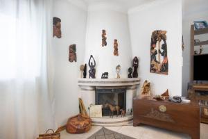 a living room with a fireplace and a tv at Casa da Mãe Maria in Buarcos
