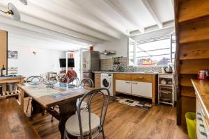 a kitchen with a table and chairs in a room at Gite Senguinous 1 in Lesparre-Médoc
