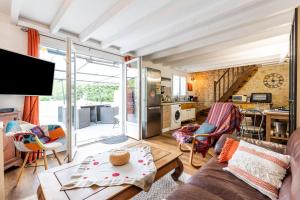 a living room with a couch and a table at Gite Senguinous 1 in Lesparre-Médoc