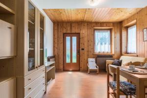 a living room with wooden walls and wooden flooring at Appartamento Adamello Casa Lucia in Pinzolo
