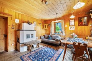 a living room with a couch and a refrigerator at Sagschneiderhof Golden Delicious in Plaus