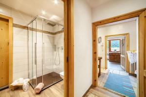 a bathroom with a shower and a glass door at Sagschneiderhof Golden Delicious in Plaus +18 photos