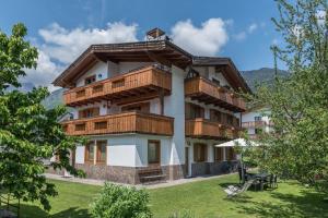 a large building with wooden balconies on it at Appartamento Adamello Casa Lucia in Pinzolo