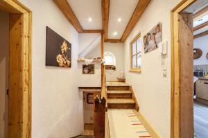 a staircase in a house with wooden beams at Sagschneiderhof Golden Delicious in Plaus