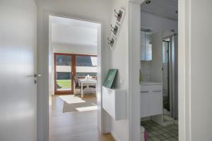 a kitchen with a door leading into a dining room at Haus am Hemm in Meldorf +72 photos