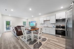 a kitchen with a table and chairs and a refrigerator at Marigold House in Foley