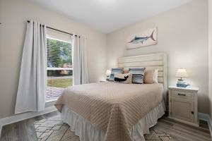 a white bedroom with a bed and a window at Marigold House in Foley +18 photos