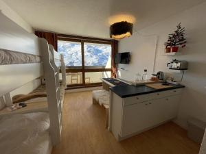 a dorm room with a bunk bed and a desk at Brelin - Combes in Les Menuires