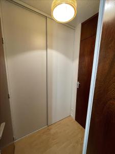 a sliding glass door in a room with a wooden floor at Brelin - Combes in Les Menuires