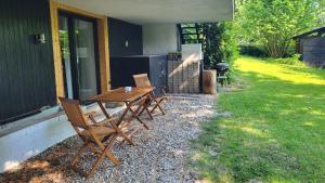 a wooden table and chairs sitting outside of a house at Ferienwohnung Burgstraße in Fuldatal
